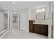 Well-lit bathroom with a modern vanity, spacious layout, and tiled floors leading to additional rooms for convenience at 7 Mockingbird Ln, Cherry Hills Village, CO 80113