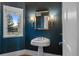 Stylish powder room featuring designer wallpaper and pedestal sink at 7 Mockingbird Ln, Cherry Hills Village, CO 80113