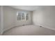 Bedroom with carpet flooring and a large window with views of trees and sky at 7 Mockingbird Ln, Cherry Hills Village, CO 80113
