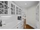 Bright butler's pantry features white cabinets, tile countertops, and access to the kitchen at 7 Mockingbird Ln, Cherry Hills Village, CO 80113