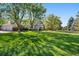 Large lot featuring a home with a well-manicured lawn and mature trees at 7 Mockingbird Ln, Cherry Hills Village, CO 80113