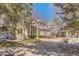 Elegant two-story home featuring a brick driveway, manicured lawn, and charming architectural details at 7 Mockingbird Ln, Cherry Hills Village, CO 80113
