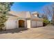 Exterior view of the home featuring a carport, multiple garages and a well-manicured lawn at 7 Mockingbird Ln, Cherry Hills Village, CO 80113