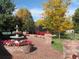 Serene fountain surrounded by colorful flowers and brick pathway leading to the tennis court at 7 Mockingbird Ln, Cherry Hills Village, CO 80113