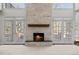 Living room with a stone fireplace and large windows with a view of the outdoors at 7 Mockingbird Ln, Cherry Hills Village, CO 80113