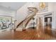 Grand foyer with a striking staircase, hardwood floors, and elegant lighting fixtures, offering a luxurious entrance at 7 Mockingbird Ln, Cherry Hills Village, CO 80113