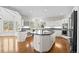 Modern kitchen boasts white cabinets, granite counters, and a large central island at 7 Mockingbird Ln, Cherry Hills Village, CO 80113
