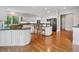 Eat-in kitchen with dual islands, granite counters, modern appliances, and white cabinets at 7 Mockingbird Ln, Cherry Hills Village, CO 80113