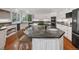 Open kitchen with a large kitchen island, granite countertops, and stainless steel appliances at 7 Mockingbird Ln, Cherry Hills Village, CO 80113