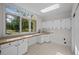 Bright laundry room with custom cabinets and a large window at 7 Mockingbird Ln, Cherry Hills Village, CO 80113