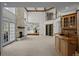 Open living space featuring stone fireplace, custom built-ins, and soaring ceilings at 7 Mockingbird Ln, Cherry Hills Village, CO 80113