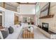 Spacious living room with a stone fireplace, high ceilings, and large windows, creating an open and inviting atmosphere at 7 Mockingbird Ln, Cherry Hills Village, CO 80113