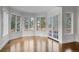 Open living room featuring hardwood floors, bay windows and access to the backyard at 7 Mockingbird Ln, Cherry Hills Village, CO 80113