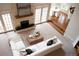 Well-lit living room featuring a stone fireplace, a neutral color scheme, and an adjacent dining area at 7 Mockingbird Ln, Cherry Hills Village, CO 80113
