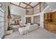 Expansive living room with a stone fireplace, a wet bar, and an open layout, ideal for entertaining and gatherings at 7 Mockingbird Ln, Cherry Hills Village, CO 80113