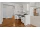 Home office featuring custom desk, built-in cabinets, and hardwood flooring at 7 Mockingbird Ln, Cherry Hills Village, CO 80113