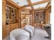 Spacious office offers custom bookshelves, wood trim, and a view of the entryway at 7 Mockingbird Ln, Cherry Hills Village, CO 80113