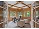 Office featuring paneled walls, coffered ceiling, bay window, and French doors at 7 Mockingbird Ln, Cherry Hills Village, CO 80113