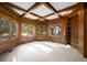 Cozy study with wood paneling, coffered ceiling, built-in bookcase, and large windows at 7 Mockingbird Ln, Cherry Hills Village, CO 80113