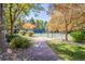 Tennis court surrounded by lush trees and greenery provides a private and serene recreational space at 7 Mockingbird Ln, Cherry Hills Village, CO 80113