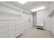 Bright walk-in closet featuring bright lighting, shelving and cabinetry at 7 Mockingbird Ln, Cherry Hills Village, CO 80113