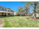 Large backyard featuring lush green grass, mature trees, and a covered patio, perfect for outdoor entertaining at 10062 Eagle Valley Way, Highlands Ranch, CO 80129