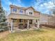 Expansive backyard with a covered patio, lush lawn, and ample space for outdoor activities and gatherings at 10062 Eagle Valley Way, Highlands Ranch, CO 80129