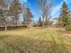 Picturesque backyard with lush lawn, mature trees, and a storage shed, ideal for outdoor activities and storage at 10062 Eagle Valley Way, Highlands Ranch, CO 80129