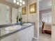 Bathroom with double sink vanity, neutral decor, and view into adjacent bedroom at 10062 Eagle Valley Way, Highlands Ranch, CO 80129
