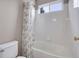 Clean, well-lit bathroom with white tiles and a modern shower curtain at 10062 Eagle Valley Way, Highlands Ranch, CO 80129