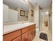 Bathroom featuring a wooden vanity, toilet, and doorway to an adjacent room at 10062 Eagle Valley Way, Highlands Ranch, CO 80129