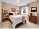 Cozy bedroom with neutral tones, carpeted floors, shelving, and ample natural light at 10062 Eagle Valley Way, Highlands Ranch, CO 80129