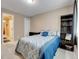 Comfortable bedroom showcasing neutral walls, plush carpet, and a view to the ensuite bathroom and walk-in closet at 10062 Eagle Valley Way, Highlands Ranch, CO 80129