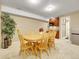Bright dining area with a wooden table, seating for six, and a small kitchen area at 10062 Eagle Valley Way, Highlands Ranch, CO 80129