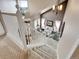 Stairway leading to a living room with vaulted ceiling and stylish decor at 10062 Eagle Valley Way, Highlands Ranch, CO 80129
