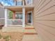 Charming covered front porch with brick steps, white columns, and seating area at 10062 Eagle Valley Way, Highlands Ranch, CO 80129