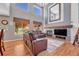 Cozy living room with hardwood floors, fireplace, and large windows, perfect for relaxation and entertainment at 10062 Eagle Valley Way, Highlands Ranch, CO 80129