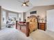 Main bedroom featuring bay window, large bed, ceiling fan, and carpeted floor at 10062 Eagle Valley Way, Highlands Ranch, CO 80129