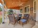 Relaxing covered patio with comfortable seating and a ceiling fan for outdoor enjoyment and entertaining at 10062 Eagle Valley Way, Highlands Ranch, CO 80129