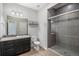 Contemporary bathroom with tiled shower, modern fixtures, and dark wood vanity at 3116 Jonquil St, Castle Rock, CO 80109