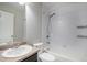 Clean bathroom with a shower-tub combo, classic vanity, and bright white tile at 3116 Jonquil St, Castle Rock, CO 80109