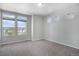 Bright bedroom with carpeted floors and three large windows with a view of the neighborhood at 3116 Jonquil St, Castle Rock, CO 80109
