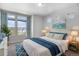 Bright bedroom with carpeted floors and three large windows with blue curtains and coordinated decor at 3116 Jonquil St, Castle Rock, CO 80109