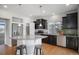 Modern kitchen featuring stainless steel appliances, dark cabinets, granite counters and eat-in island at 3116 Jonquil St, Castle Rock, CO 80109