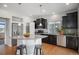 Modern kitchen featuring stainless steel appliances, dark cabinets, granite counters and eat-in island at 3116 Jonquil St, Castle Rock, CO 80109