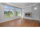 Bright living room with hardwood floors, a modern fireplace, and large windows overlooking the neighborhood at 3116 Jonquil St, Castle Rock, CO 80109