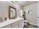 Bright bathroom with vanity, decorative mirror, and modern fixtures at 12818 Ironstone Way # 101, Parker, CO 80134