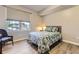 Comfortable bedroom with natural light from a window, featuring light walls and wood-look flooring at 12818 Ironstone Way # 101, Parker, CO 80134