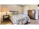 Cozy bedroom features patterned bedspread, complementary decor, light walls and wood-look flooring at 12818 Ironstone Way # 101, Parker, CO 80134