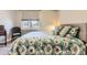Inviting bedroom with a large window, a chair and light colored walls and wood-look flooring at 12818 Ironstone Way # 101, Parker, CO 80134